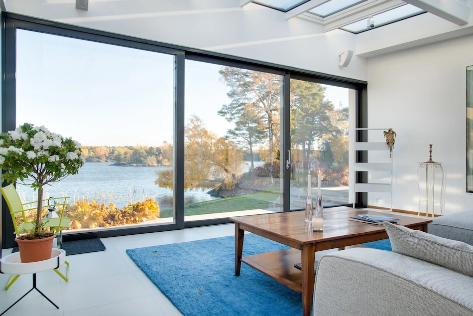 New high-efficiency windows in this bright waterfront living room installed by Landmark Exteriors in Livermore CA.